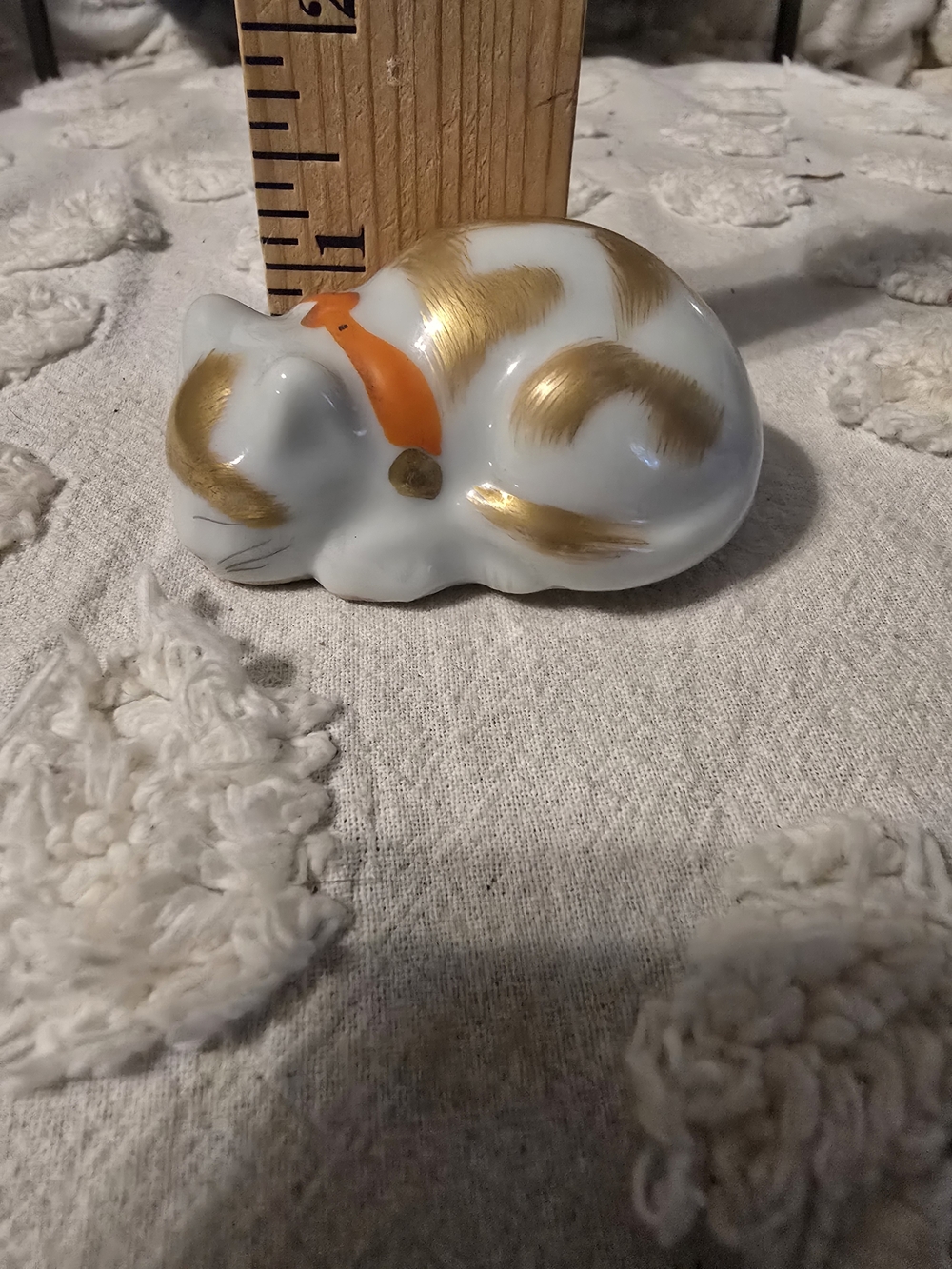 White Ceramic Sleeping Cat Figurine with Gold Accents and Orange Collar